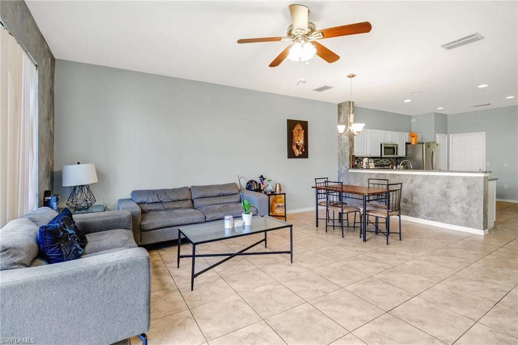 977 Hampton Circle, Unit 118 Naples, FL 34105 - Photo 11 of 24 a living room with furniture and a view of kitchen