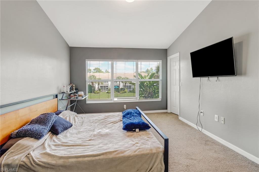 977 Hampton Circle, Unit 118 Naples, FL 34105 - Photo 14 of 24 a living room with furniture and a flat screen tv
