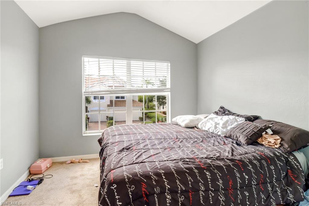 977 Hampton Circle, Unit 118 Naples, FL 34105 - Photo 18 of 24 a bedroom with a bed and a window