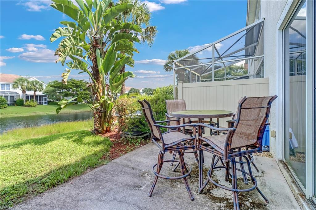 977 Hampton Circle, Unit 118 Naples, FL 34105 - Photo 20 of 24 a view of a chairs and table in the patio