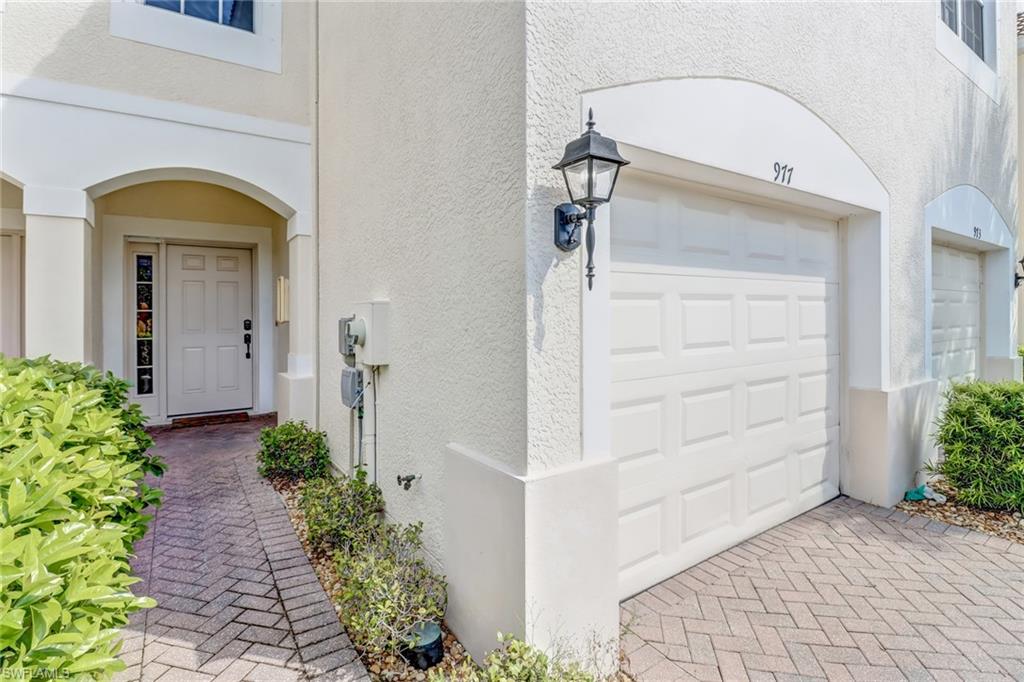 977 Hampton Circle, Unit 118 Naples, FL 34105 - Photo 2 of 24 a front view of a house with a porch