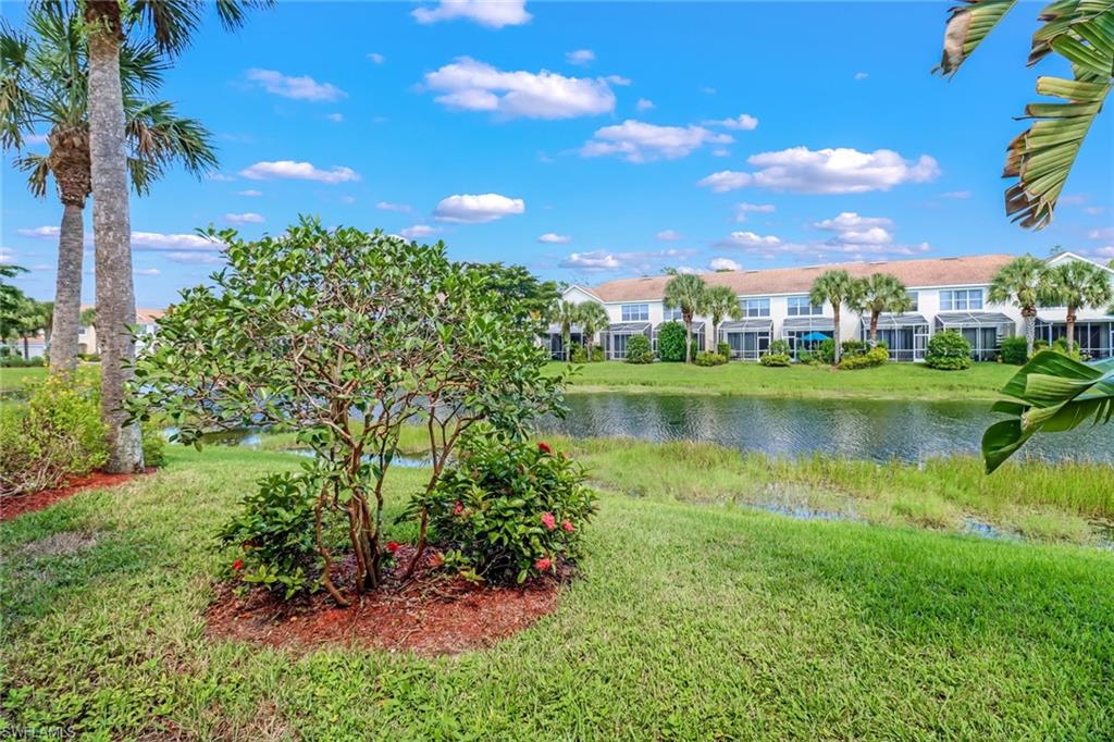 977 Hampton Circle, Unit 118 Naples, FL 34105 - Photo 21 of 24 a view of a lake with a house in the background