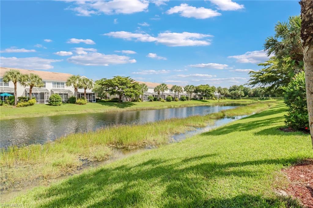 977 Hampton Circle, Unit 118 Naples, FL 34105 - Photo 23 of 24 a view of a lake with houses in the back