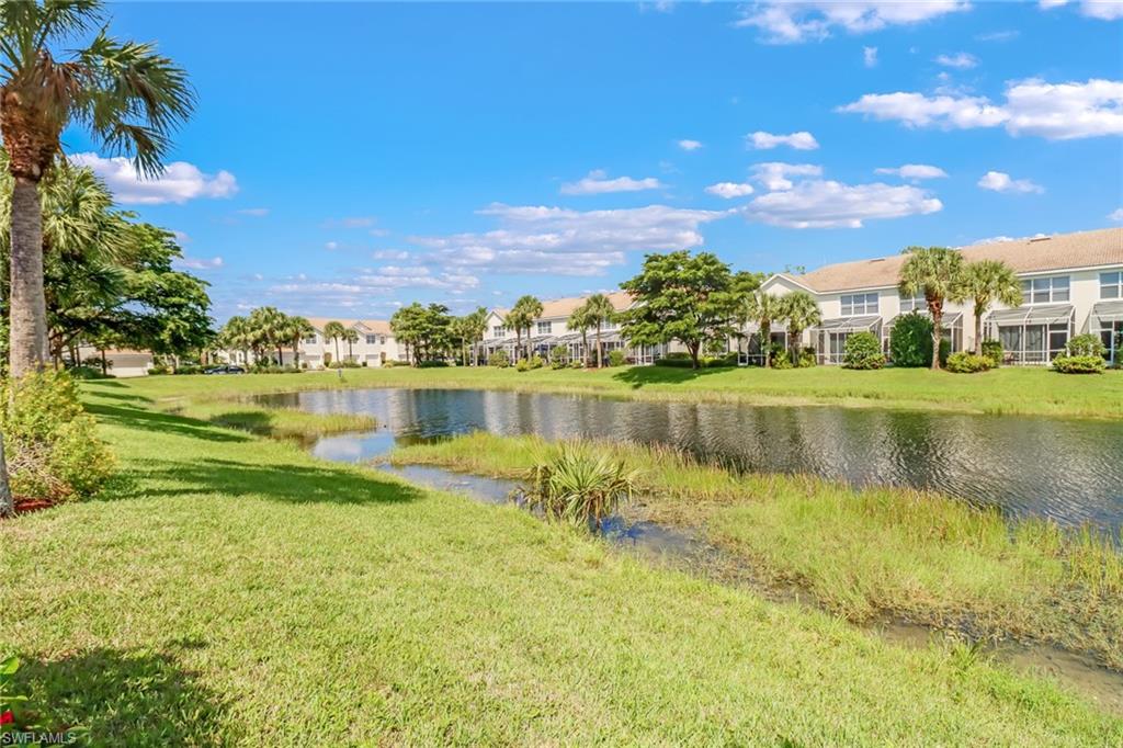 977 Hampton Circle, Unit 118 Naples, FL 34105 - Photo 24 of 24 a view of a lake with houses in the back