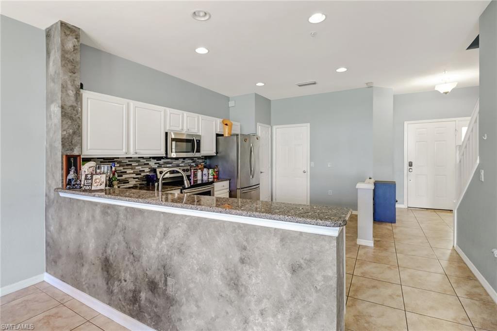 977 Hampton Circle, Unit 118 Naples, FL 34105 - Photo 3 of 24 a view of a kitchen with a sink