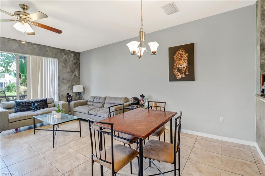 977 Hampton Circle, Unit 118 Naples, FL 34105 - Photo 7 of 24 a view of a dining room with furniture window and outside view