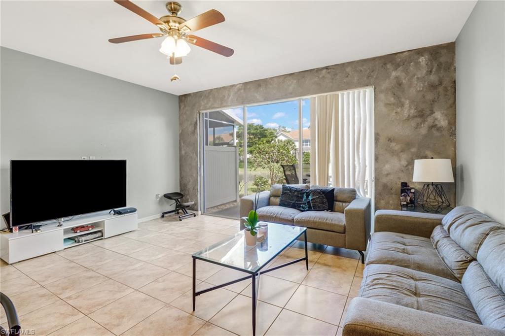 977 Hampton Circle, Unit 118 Naples, FL 34105 - Photo 10 of 24 a living room with furniture and a flat screen tv
