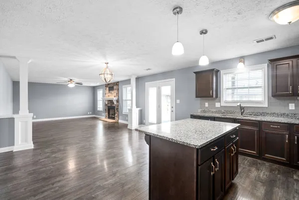 a kitchen with center island table and chairs