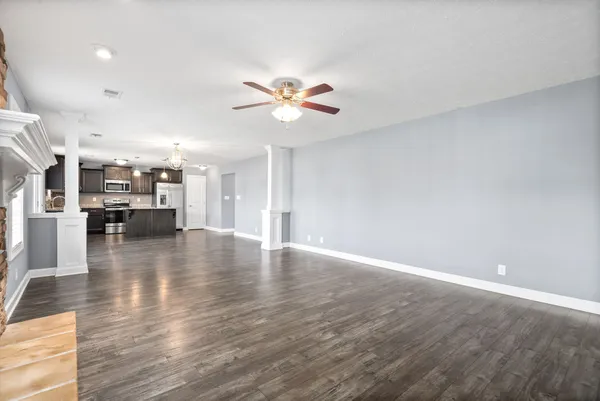 a view of kitchen and hall with wooden floor
