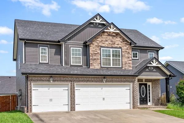 a front view of a house with garage