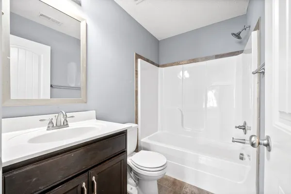 a bathroom with a sink a toilet and a bathtub