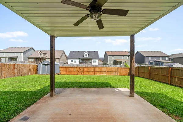 a view of a backyard with swimming pool