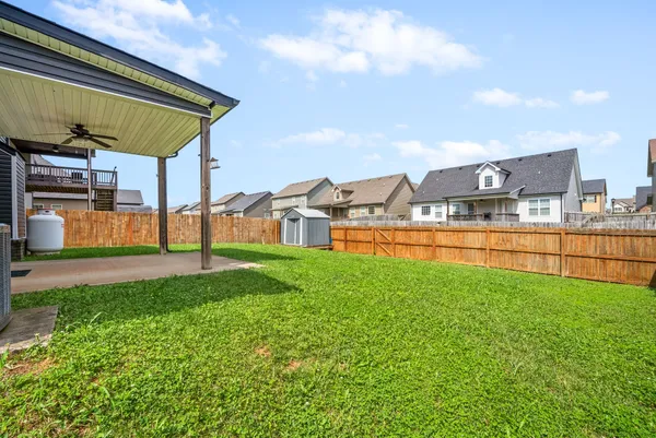 a view of a house with a yard and sitting area