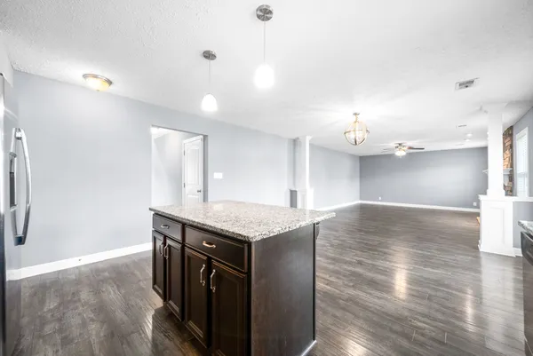 a kitchen with a wooden floor and window