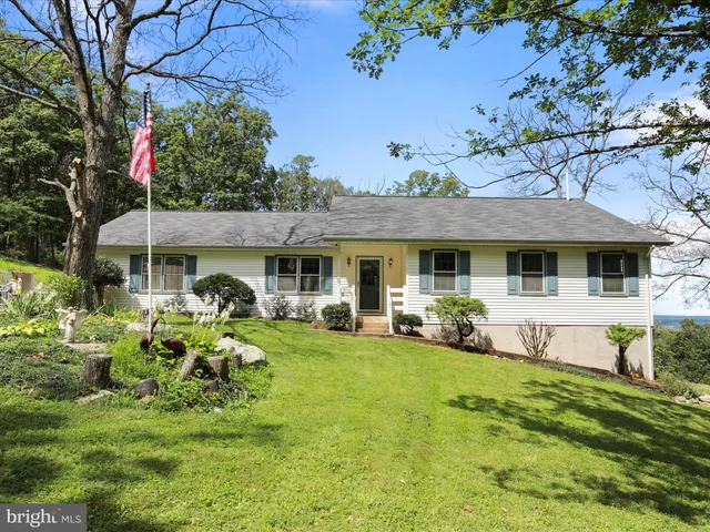 a front view of a house with a garden and patio