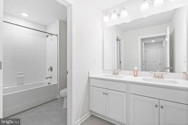 a bathroom with a double vanity sink mirror double and shower