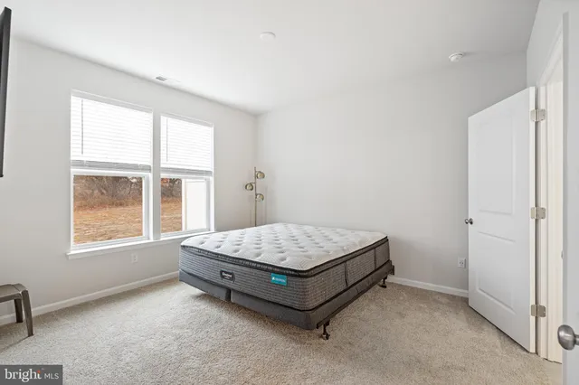 a room with a bed and window