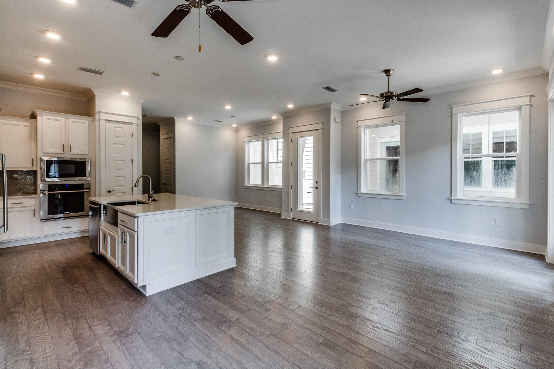 100 W Pine, Unit 527A Inlet Beach, FL 32461 - Photo 2 of 37 an open kitchen with kitchen island white cabinets and wooden floor