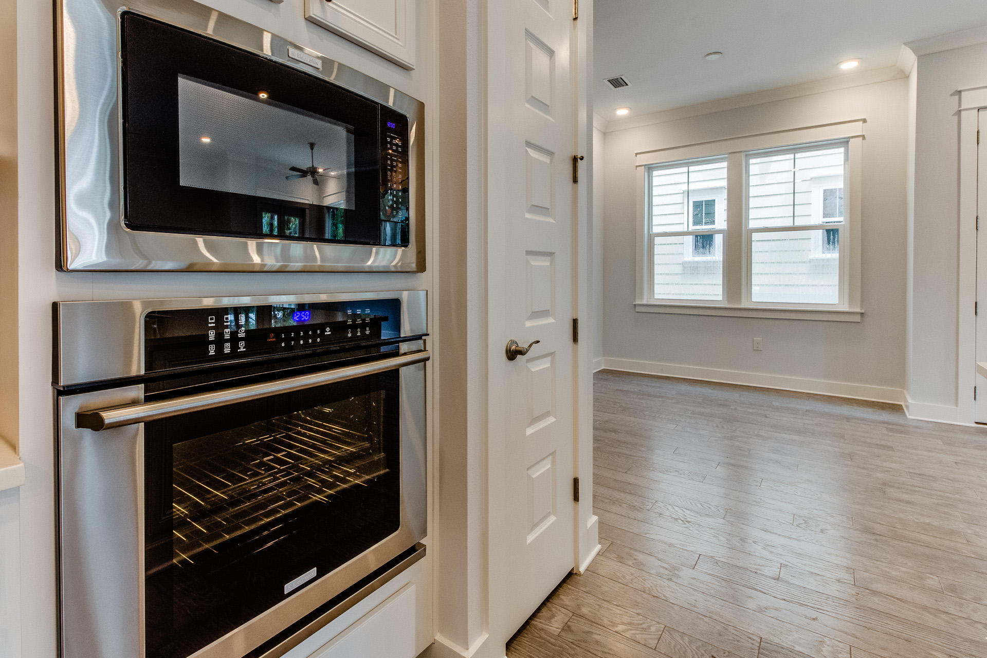 100 W Pine, Unit 527A Inlet Beach, FL 32461 - Photo 25 of 37 a room with wooden floor and a stove top oven