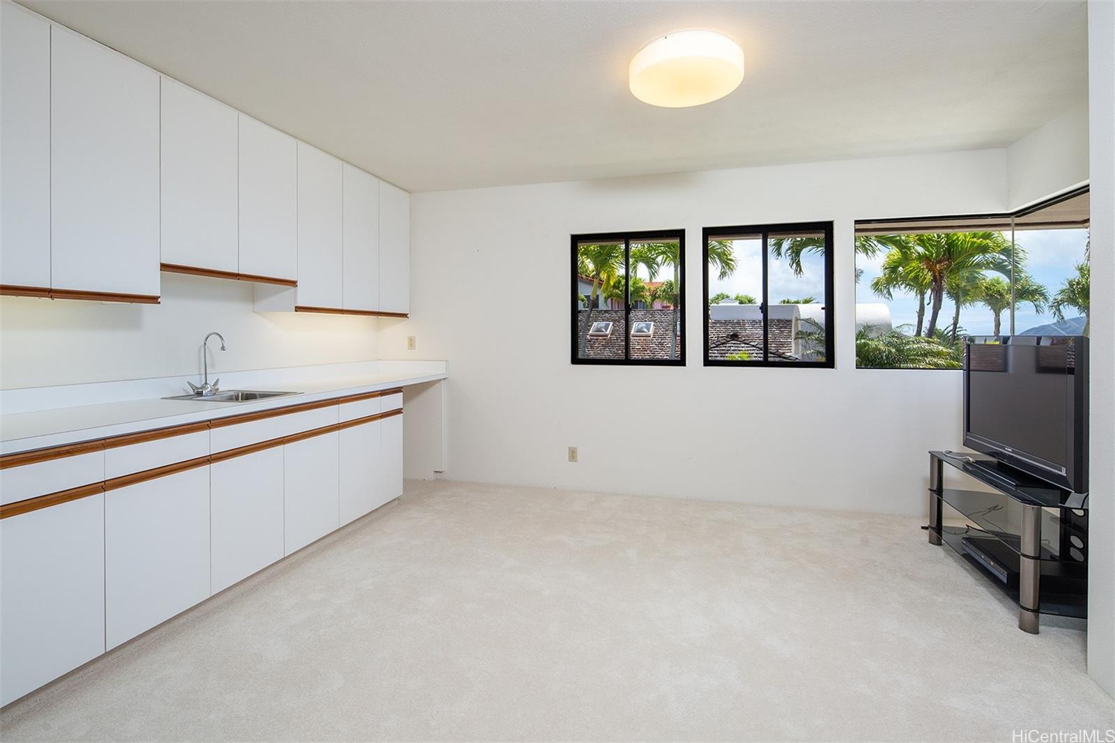 154 Maono Place Honolulu, HI 96821 - Photo 17 of 25 a large white kitchen with a sink and dishwasher a microwave oven
