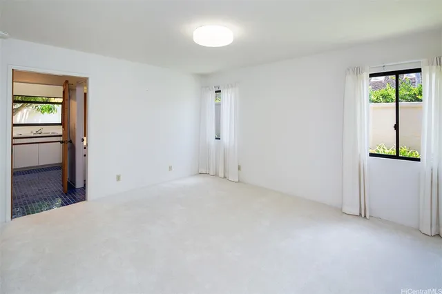 an empty room with windows and closet