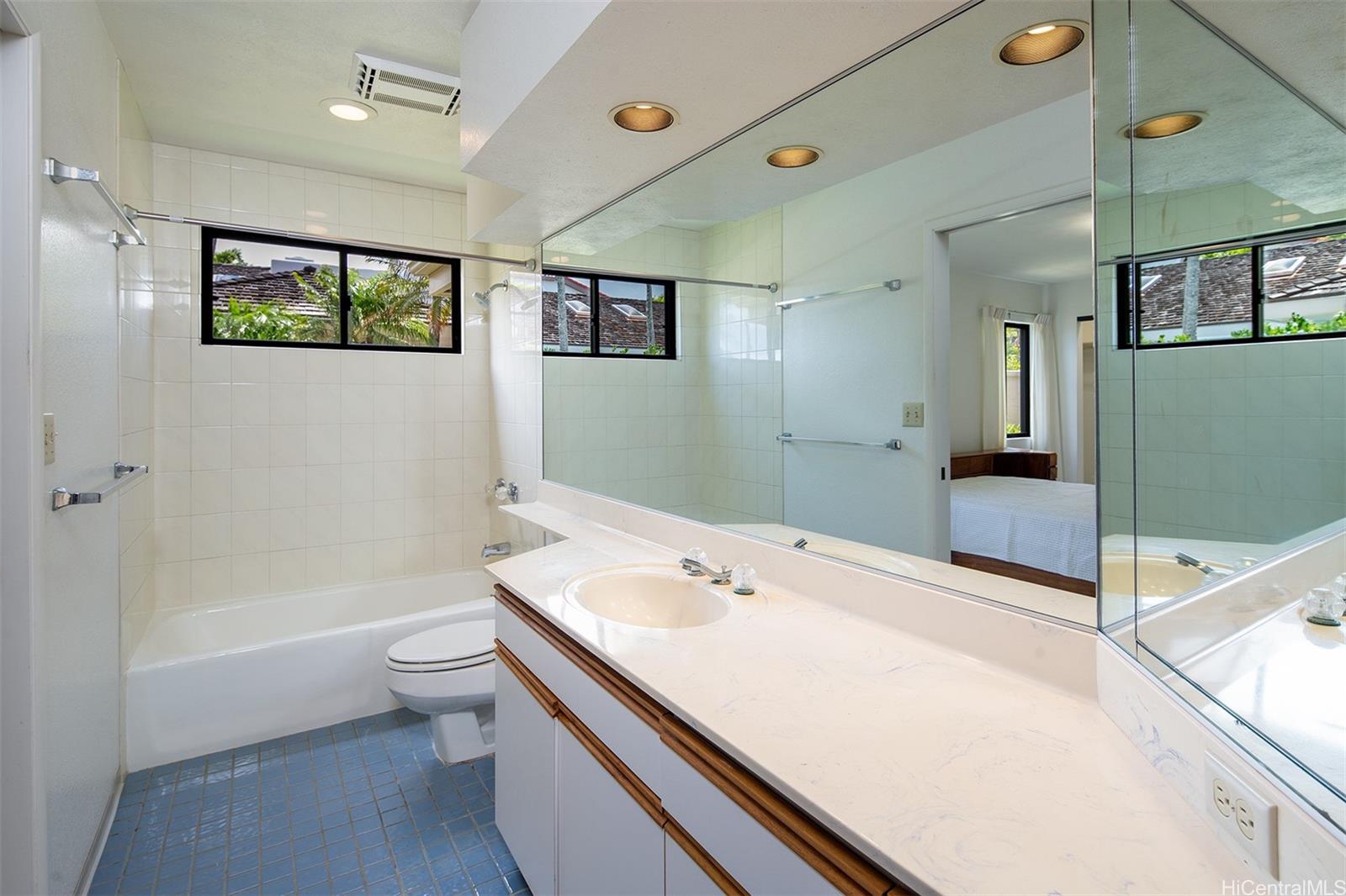 154 Maono Place Honolulu, HI 96821 - Photo 23 of 25 a bathroom with a bathtub a sink and a large mirror