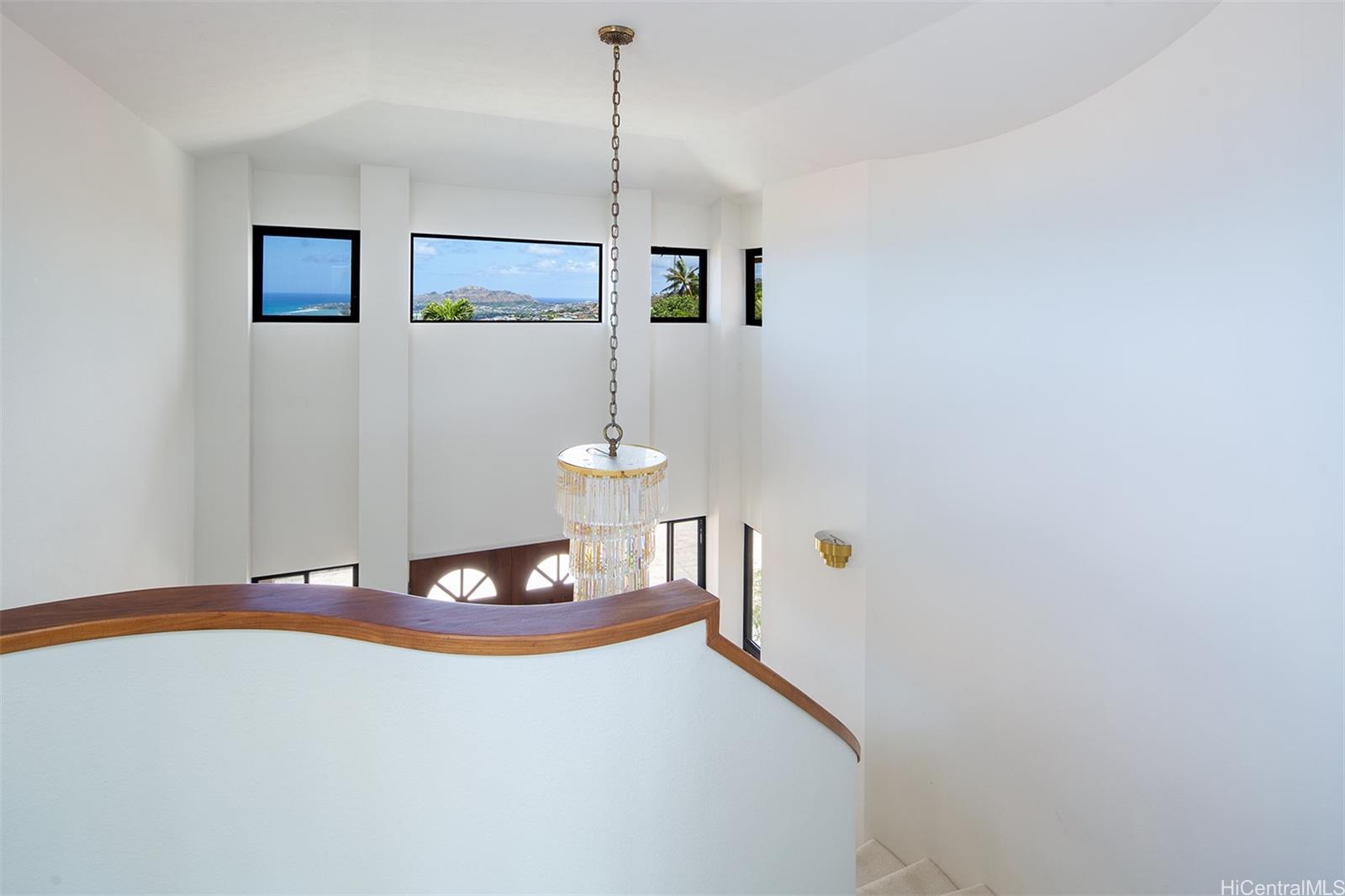 154 Maono Place Honolulu, HI 96821 - Photo 24 of 25 a bedroom with a bed and a chandelier