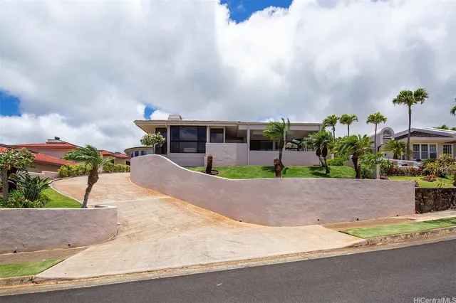 an aerial view of a house with a yard and sitting area