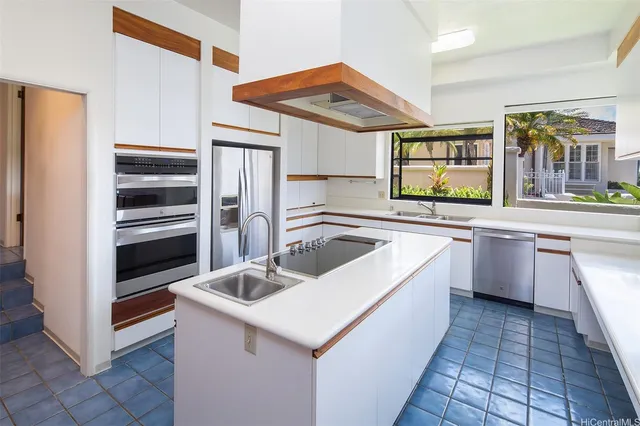 a kitchen with a sink stove and refrigerator
