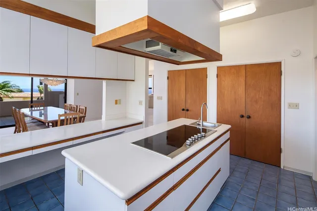 a kitchen that has a sink and a stove in it