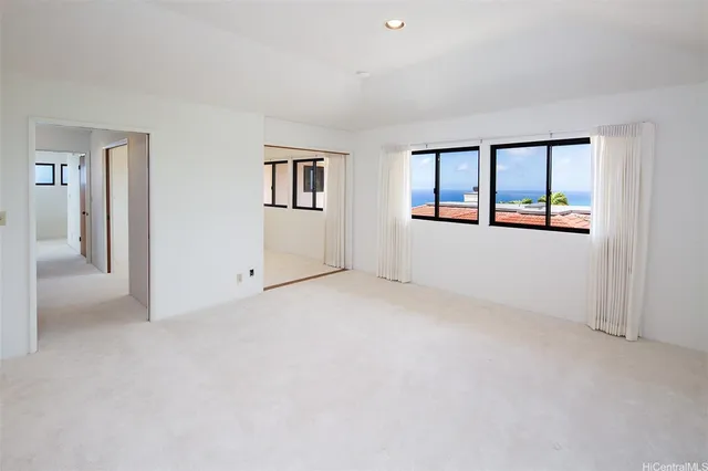 an empty room with windows and closet