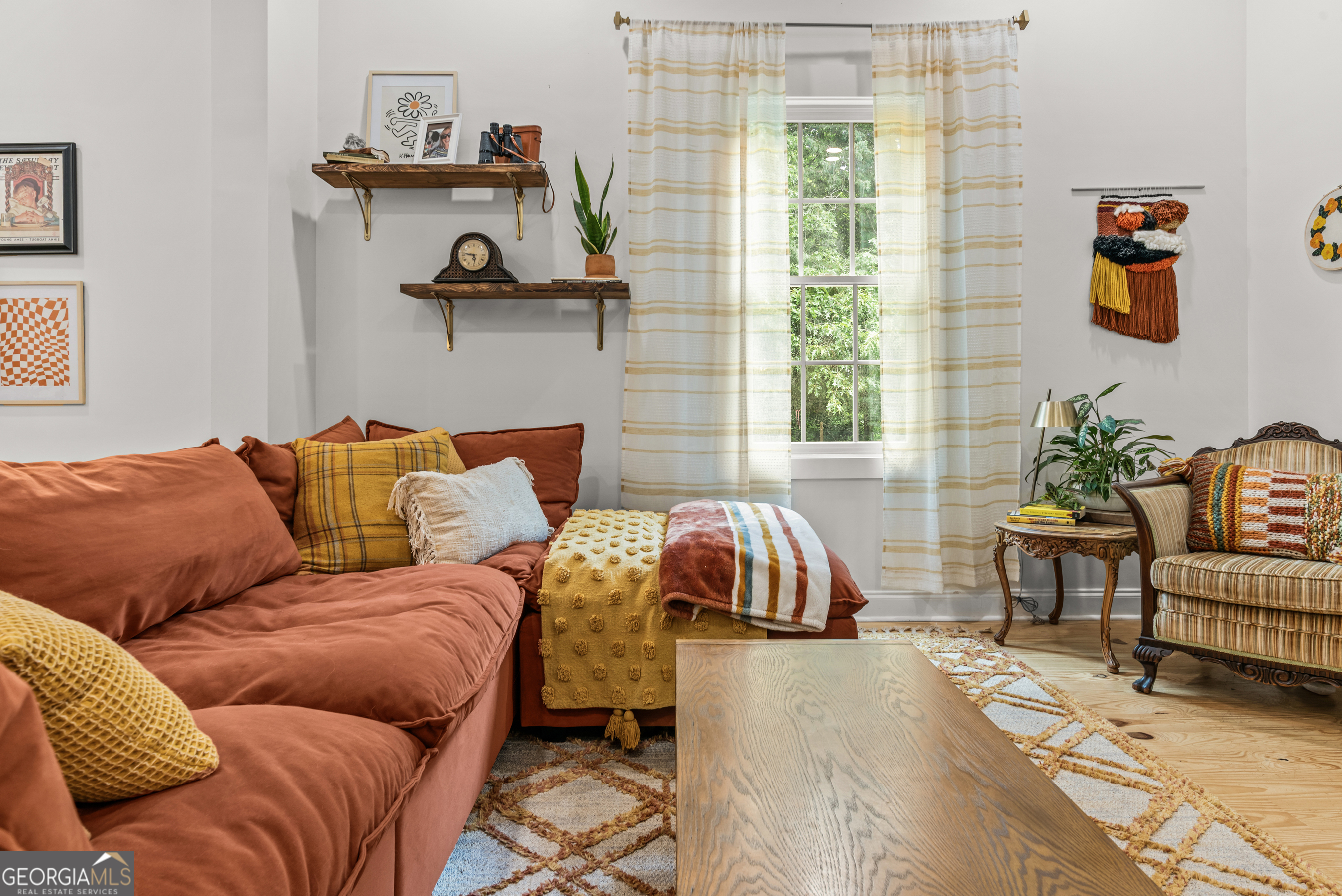 1580 Farmington Road Madison, GA 30650 - Photo 13 of 52 a living room with a couch and a window