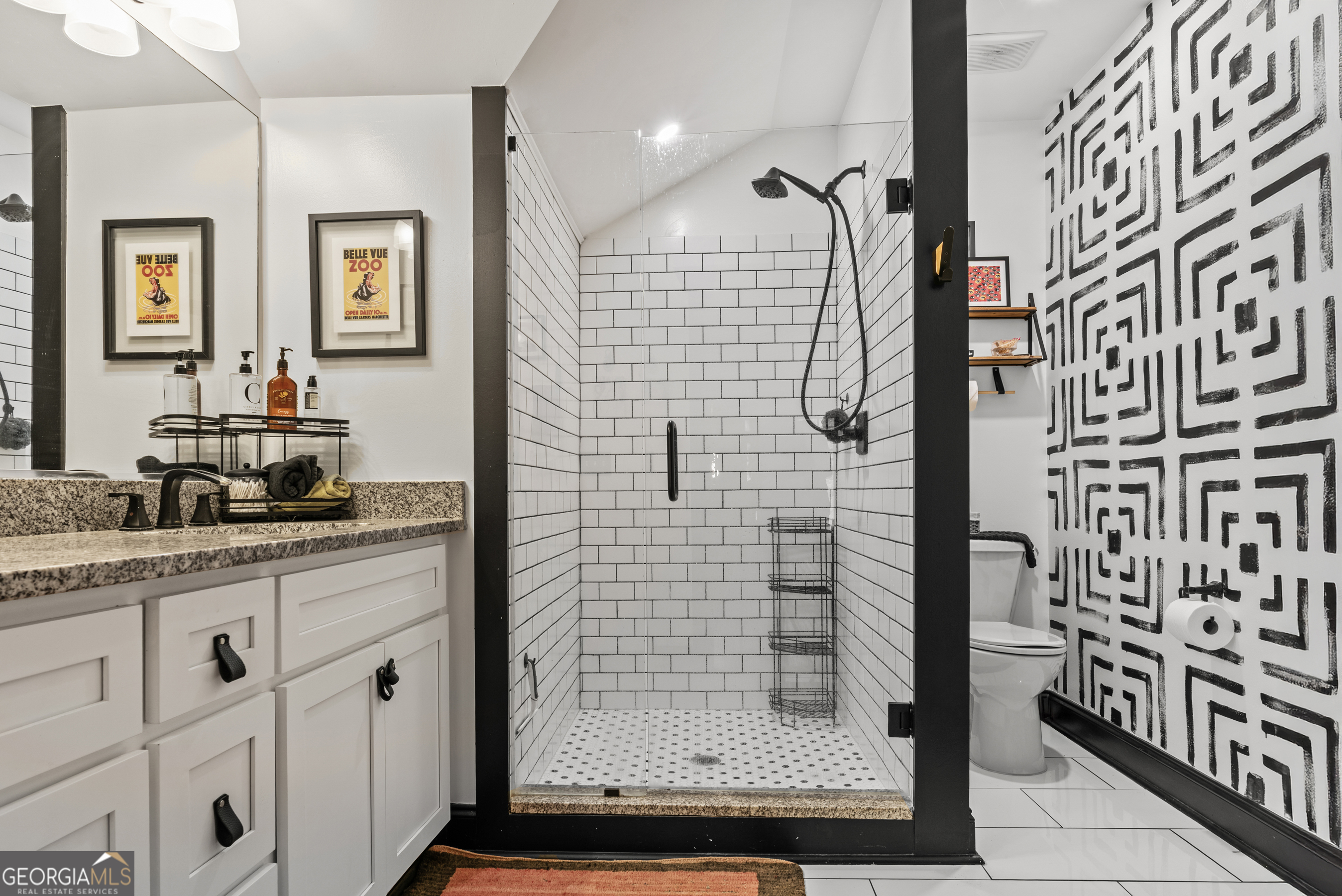 1580 Farmington Road Madison, GA 30650 - Photo 27 of 52 a bathroom with a granite countertop shower a sink and a mirror