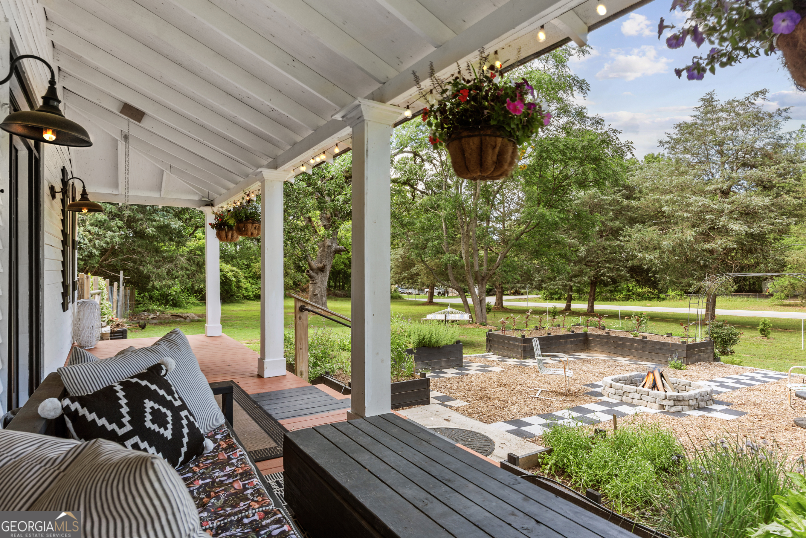 1580 Farmington Road Madison, GA 30650 - Photo 3 of 52 a view of a patio with table and chairs potted plants and floor to ceiling window