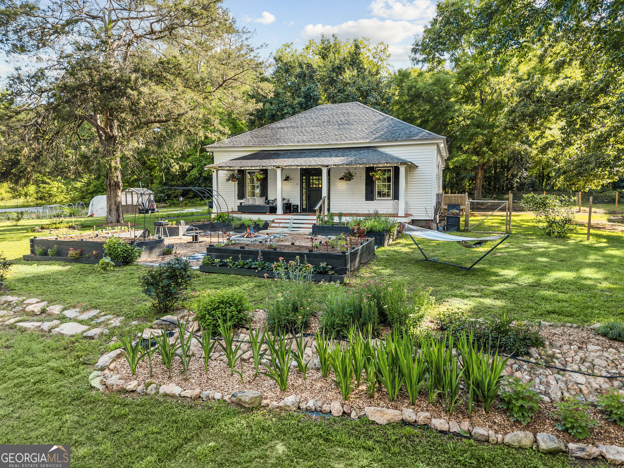 1580 Farmington Road Madison, GA 30650 - Photo 46 of 52 a front view of a house with garden