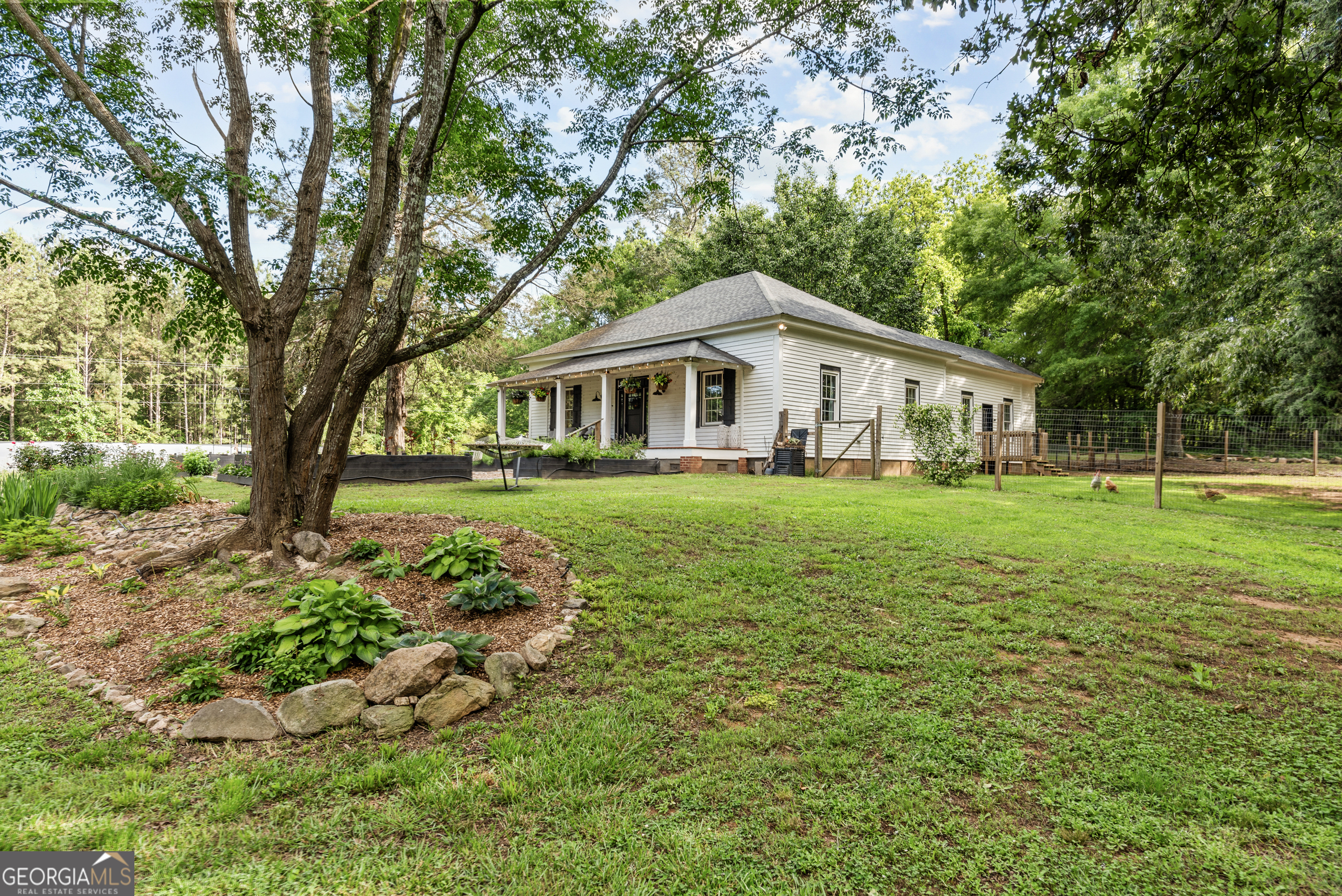 1580 Farmington Road Madison, GA 30650 - Photo 51 of 52 a view of house with a big yard and large trees