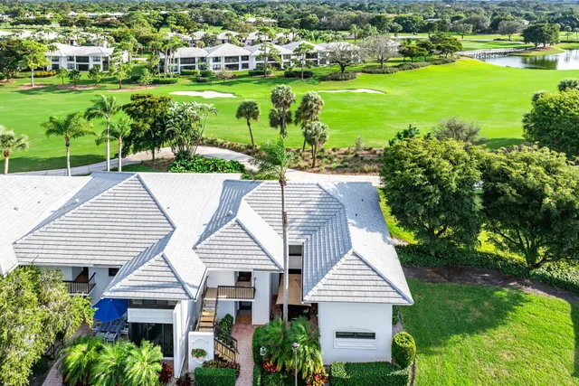 a aerial view of a house with a yard and lake view