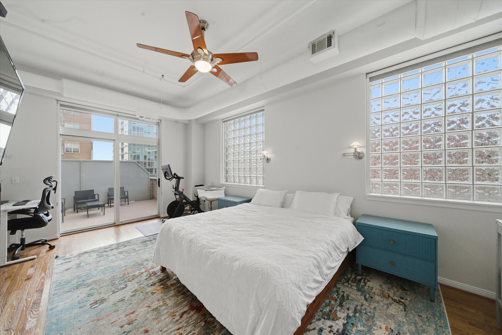 950 West Monroe Street, Unit 401 Chicago, IL 60607 - Photo 13 of 27 a bedroom with a bed a couch and a window