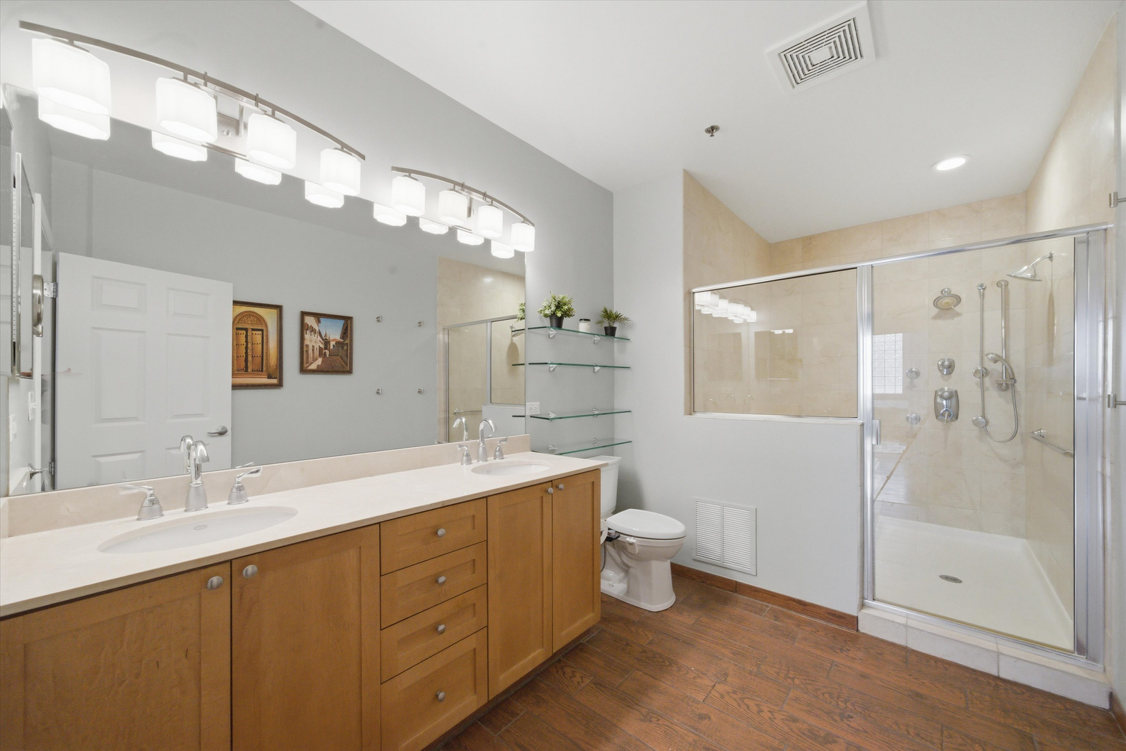 950 West Monroe Street, Unit 401 Chicago, IL 60607 - Photo 16 of 27 a bathroom with a double vanity sink mirror double shower and a toilet