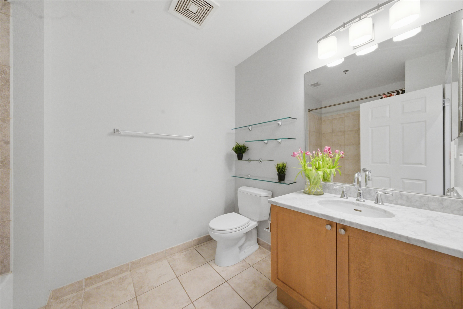 950 West Monroe Street, Unit 401 Chicago, IL 60607 - Photo 20 of 27 a bathroom with a granite countertop sink a toilet and a mirror