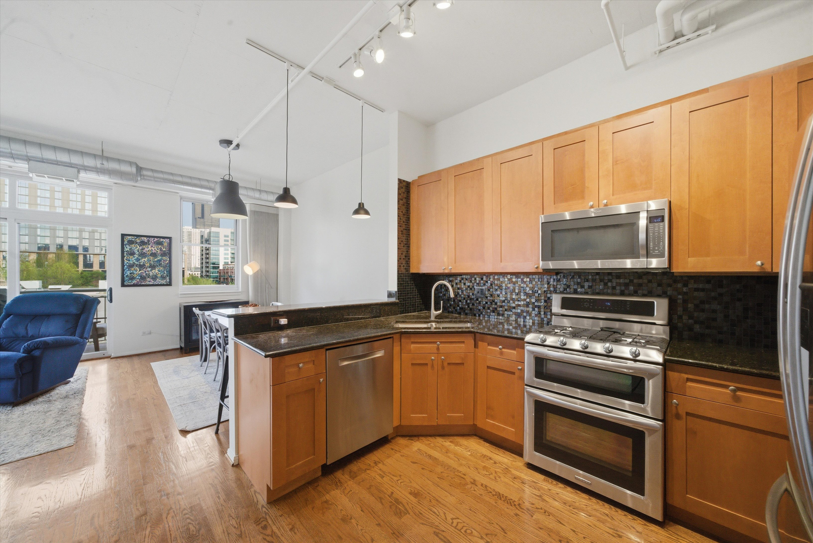 950 West Monroe Street, Unit 401 Chicago, IL 60607 - Photo 5 of 27 a kitchen with stainless steel appliances granite countertop a stove a sink and a refrigerator