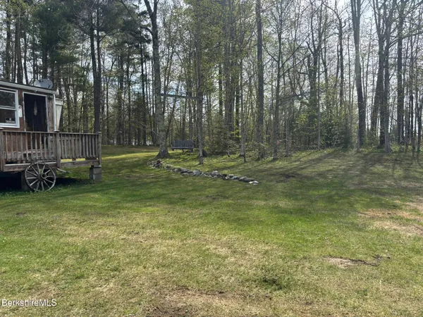 a backyard of a house with lots of green space and deers