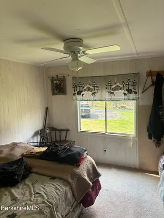 a bedroom with a bed and window
