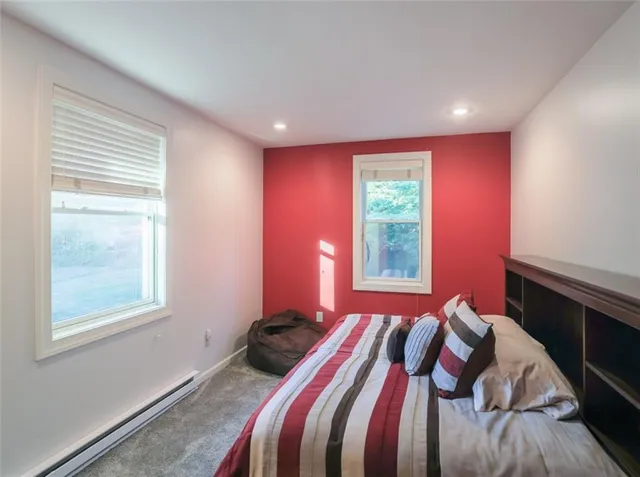 a bed sitting in a bedroom next to a window