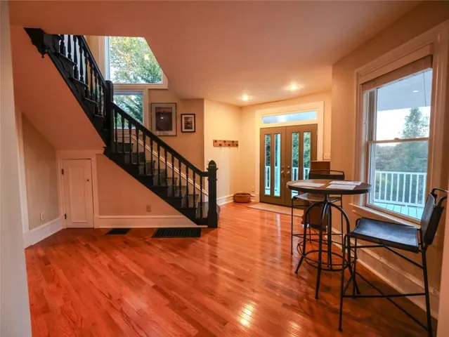 a view of a livingroom with furniture stairs windows and a chandelier