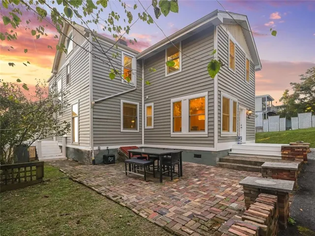 a backyard of a house with outdoor seating