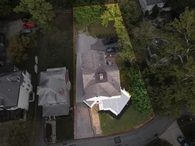 an aerial view of a house with a yard