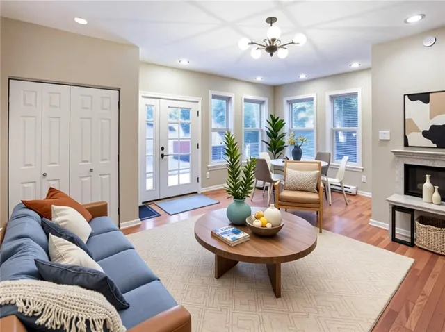 a living room with furniture potted plant and wooden floor