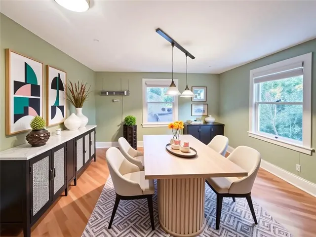 a view of a dining room with furniture window and wooden floor