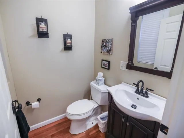 a bathroom with a sink mirror and toilet